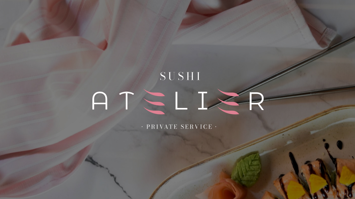 Sushi Atelier logo with decorative pink accents over marble surface, chopsticks, and a plate of sushi with garnish.